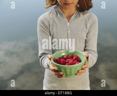 Seattle Washington USA Nine year old girl bowl of organic raspberries Stock Photo