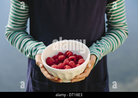 Seattle Washington USA Nine year old girl bowl organic raspberries Stock Photo