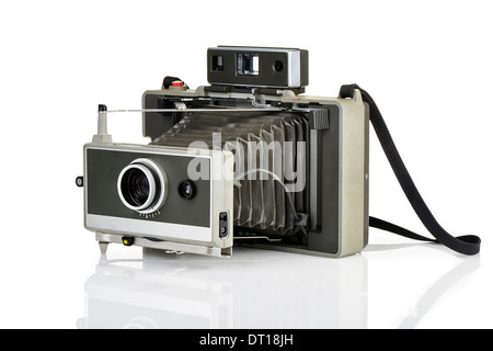 Vintage instant camera and his reflection on white background Stock Photo