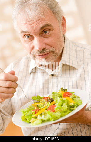 Senior Mature Man Eat Vegetable Salad At Wooden Table Stock Photo - Alamy