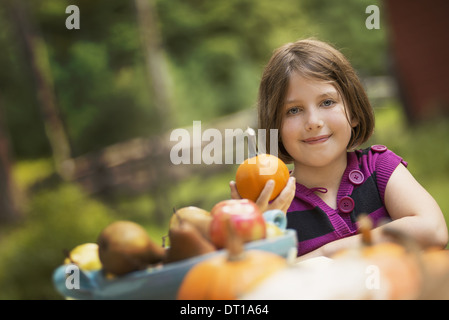 Woodstock New York USA young girl holding pumpkin in her hand at table Stock Photo