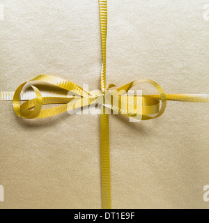 tied bow and gold ribbon from wrapped gift Stock Photo