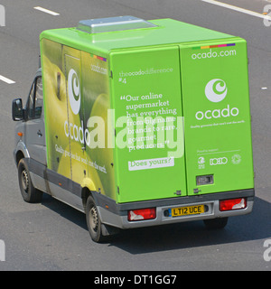 Side back rear & roof aerial view from above looking down green Ocado online grocery food shopping delivery van & logo driving on English UK motorway Stock Photo