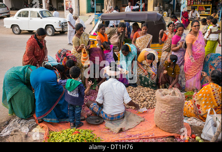 Indian women buying vegetables from a street market in Puttaparthi, Andhra Pradesh, India Stock Photo