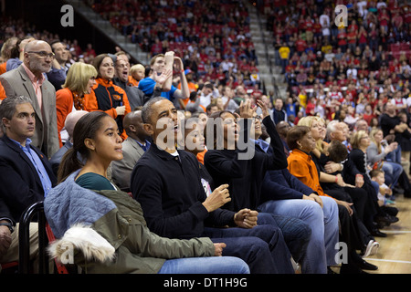 US President Barack Obama, First Lady Michelle Obama, daughters Malia and Sasha, and Marian Robinson attend the Oregon State University vs. University of Maryland men's basketball game at the Comcast Center November 17, 2013 in College Park, MD. Stock Photo