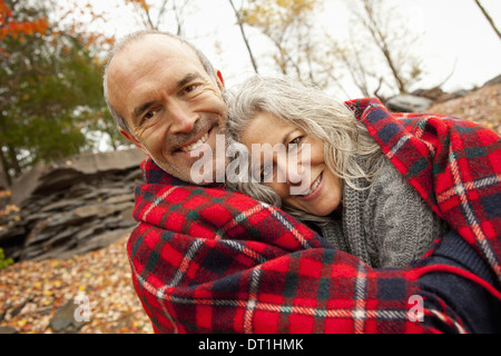 A couple man and woman on a day out in autumn Sharing a picnic rug to keep warm