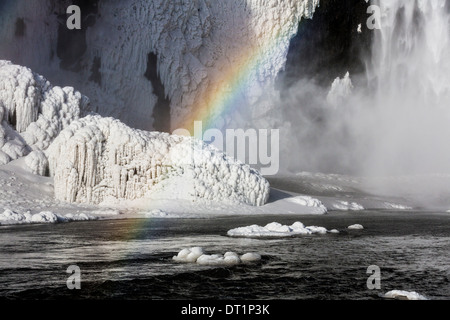 Rainbow over Skogafoss Waterfall in the Winter, Iceland Stock Photo