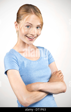 Young woman with arms folded, portrait Stock Photo