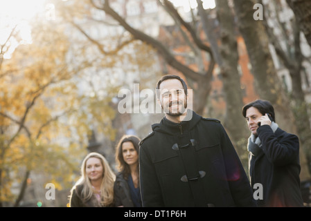 Adult group in urban park man in front Stock Photo