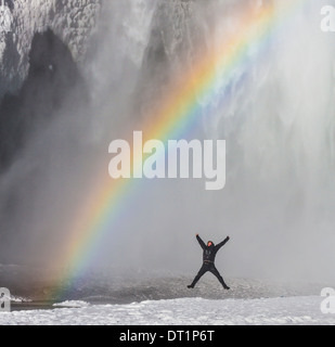 Rainbow over Skogafoss Waterfall in the Winter, Iceland Stock Photo