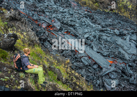 Man watching an active lava stream, Tolbachik volcano, Kamchatka, Russia, Eurasia Stock Photo