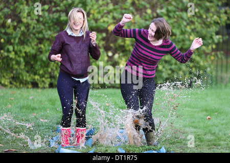 PEOPLE PRACTISING  PUDDLE JUMPING TECHNIQUE AT WICKSTEED PARK,KETTERING,NORTHANTS, Stock Photo