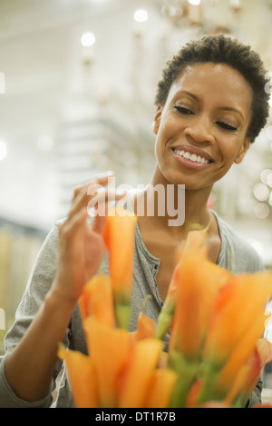 African American woman arranging flowers Stock Photo - Alamy