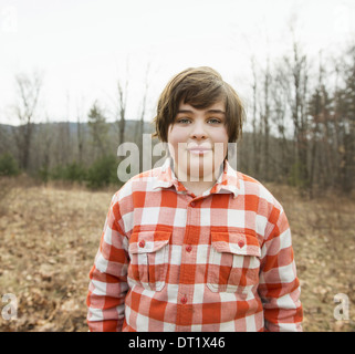 A young boy in a red checked shirt outside on a winter's day Stock Photo