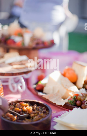 A table laid with a buffet selection of food dishes Desserts and cheese board Stock Photo