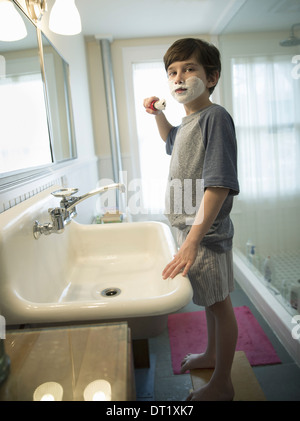 Young boy child standing in his bedroom wearing a pull up nappy