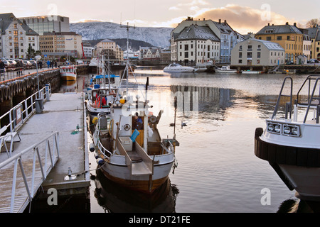 Fishing boats in the old harbour at Ålesund, Norway, a town famous Art Nouveau architecture Stock Photo