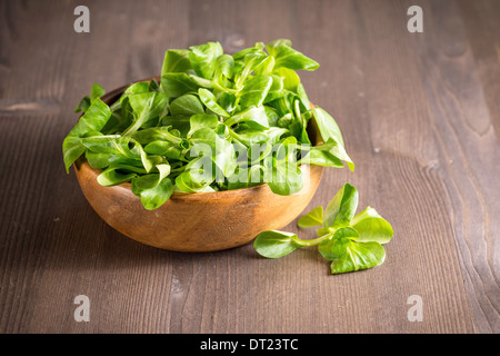 Corn salad in a wooden bowl on the table Stock Photo