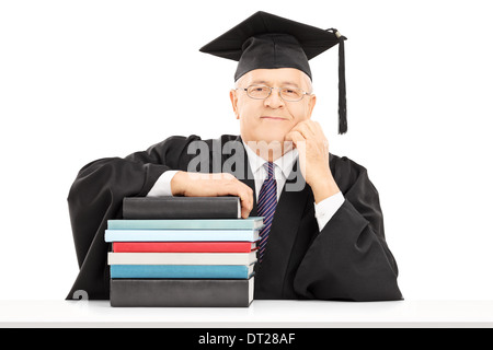 Middle aged college professor posing with a stack of books Stock Photo