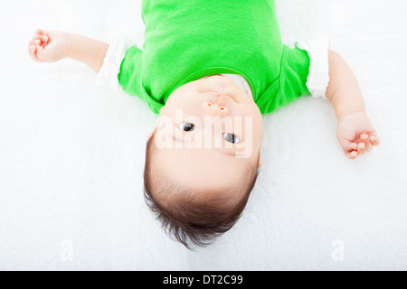 Baby having laughing and lying on the towel Stock Photo