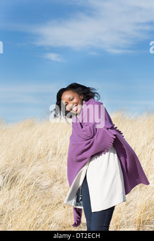 USA, Illinois, Waukegan, Portrait of young woman wrapped in blanket Stock Photo