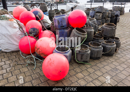 Lobster and Crab Pots and Red Fluorescent Buoys on Quayside Stock Photo