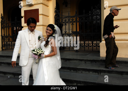 Newlyweds have their photographs taken on the steps of the French built Opera House. Stock Photo