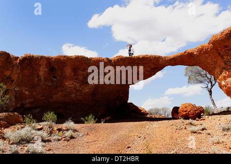 Woman standing on stone formation, known as the London Bridge near the goldfields town of Sandstone, Western Australia Stock Photo