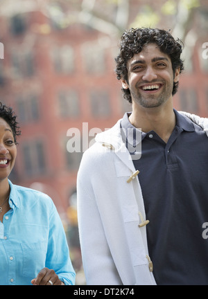 Side View Of Young Man And Woman Smiling And Looking At Each Other 