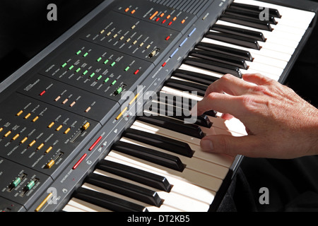 An electronic musical keyboard instrument being played showing the ...