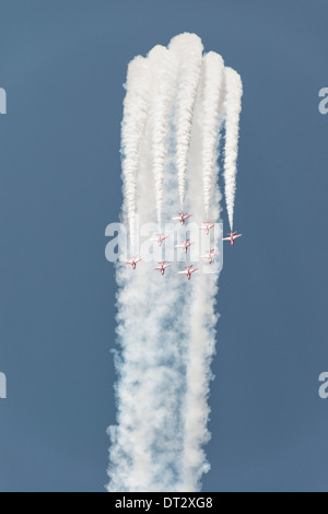 The British Red Arrows Military aerobatic display team in their signature diamond nine formation dive out of a blue sky at RIAT Stock Photo