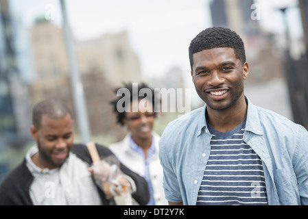 Three people a couple and a young man Stock Photo