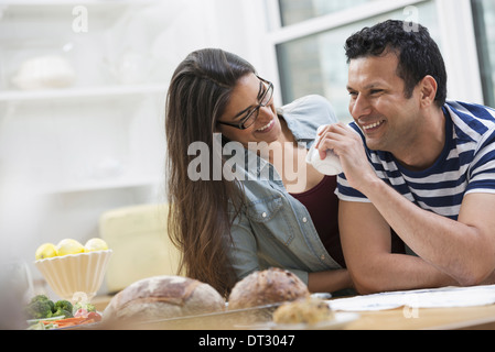 An office or apartment interior in New York City Two people a couple beside the breakfast bar Stock Photo