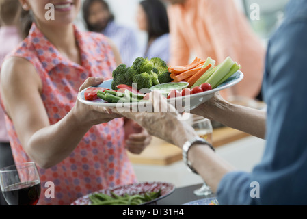 salad buffet of mixed ages and ethnicities meeting together Stock Photo