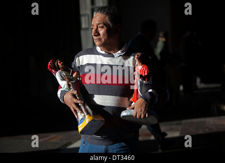 A man carries images of Saint Jude Thaddeus and Sain Juan Diego at the pilgrimage to Our Lady of Guadalupe Basilica in Mexico Stock Photo