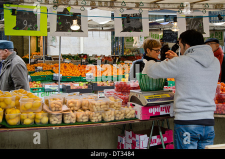 Aligre outdoor food market, busy fruit and vegetables outdoor market at the square of Aligre and street, rue Aligre. Paris, France. Stock Photo