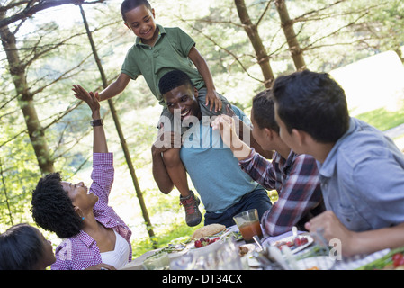 A young boy sitting on his father's shoulders Stock Photo