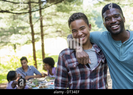 A man and a young boy looking at the camera Stock Photo