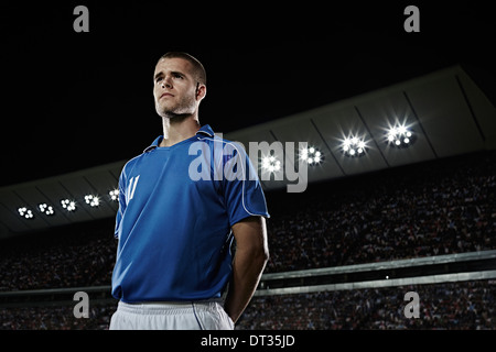 Soccer player standing in stadium Stock Photo