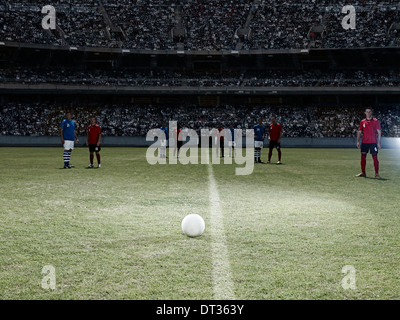 Soccer ball sitting on field Stock Photo
