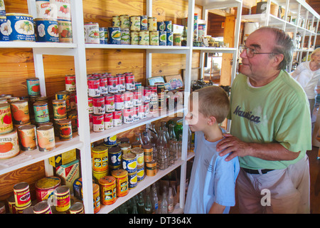Florida Sanibel Barrier Island,Sanibel historical history Museum and Village,general store,shelf shelves shelving,cans,canned goods,boy boys,male kid Stock Photo