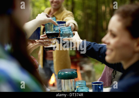 A campsite clearing in the woods People seated Stock Photo