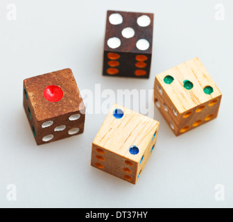 four wooden gambling dices on white table close up Stock Photo