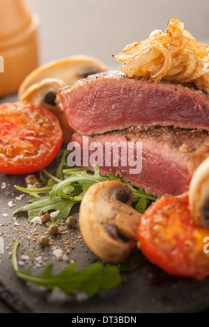 Rare steak with tomato and mushrooms Stock Photo