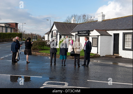 Wedding guests outside The Old Blacksmith's Shop in Gretna Green, Scotland Stock Photo