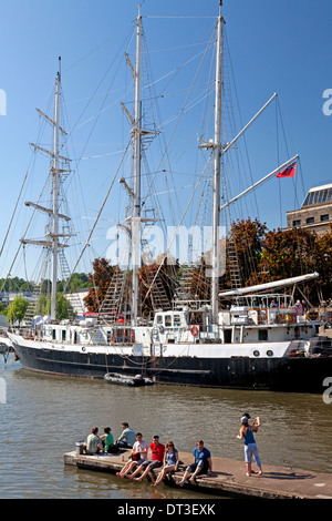 Tall ship 'Lord Nelson' in Bristol docks, with people enjoying a summer afternoon on the jetty