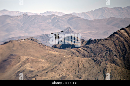 A US Army CH-47F Chinook helicopter flies over western Afghanistan April 12, 2012 on the way to FOB Shindand, Herat province, Afghanistan. Stock Photo