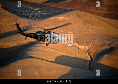 A US Army UH-60 Black Hawk helicopter flies over western Afghanistan April 12, 2012 on the way to FOB Shindand, Herat province, Afghanistan. Stock Photo