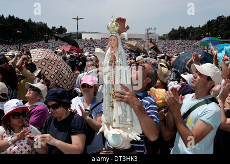 Pilgrim hold the statue during the procession of Fatima in central Portugal .Thousands of pilgrims converged on Fatima Santuary Stock Photo