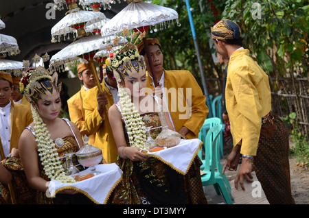 A number of girls served to bring liquor offerings to ancestors at the tomb of Prabu Anom in Doko village. Stock Photo